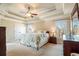 Large main bedroom with a coffered ceiling, plush carpet, and a sitting area at 6610 Wesley Trail Holw, Cumming, GA 30028