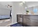 Double vanity bathroom with modern fixtures and a view into the bedroom at 11988 Lovejoy Crossing Pl, Hampton, GA 30228
