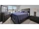 Cozy bedroom with a queen-size bed, dresser, and window at 11988 Lovejoy Crossing Pl, Hampton, GA 30228