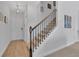 Bright foyer with hardwood floors, staircase, and stylish decor at 11988 Lovejoy Crossing Pl, Hampton, GA 30228