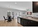 Open kitchen with an island and breakfast bar, looking toward dining area at 11988 Lovejoy Crossing Pl, Hampton, GA 30228