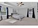 Spacious main bedroom with a king-size bed and ample natural light at 11988 Lovejoy Crossing Pl, Hampton, GA 30228