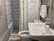 Clean bathroom with white tile, shower, toilet and sink at 4198 Arc Way, Norcross, GA 30093