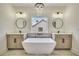 Luxurious bathroom with double vanity, soaking tub, and chandelier at 4265 Haynes Cir, Snellville, GA 30039