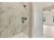 Modern bathroom with a walk-in shower, marble tile, and glass door at 4265 Haynes Cir, Snellville, GA 30039