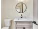 Modern bathroom with a floating vanity and round mirror at 4265 Haynes Cir, Snellville, GA 30039