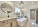 Luxurious bathroom with double vanity, soaking tub, and chandelier at 4265 Haynes Cir, Snellville, GA 30039