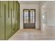 Bright entryway with double doors and an olive green accent wall at 4265 Haynes Cir, Snellville, GA 30039
