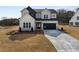 Two-story farmhouse with gray siding, black accents, and a long driveway at 4265 Haynes Cir, Snellville, GA 30039