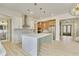 Open concept kitchen with island, stainless steel appliances, and herringbone backsplash at 4265 Haynes Cir, Snellville, GA 30039