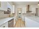Modern kitchen with white cabinets, quartz countertops, and gold hardware at 4265 Haynes Cir, Snellville, GA 30039