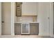 Basement wet bar with gray cabinets, gold handles, and hexagon tile backsplash at 4265 Haynes Cir, Snellville, GA 30039