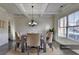 Elegant dining room with modern chandelier, neutral decor, and a large window at 4610 Point Rock Dr, Buford, GA 30519