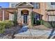 Close-up of the front door with stone archway and manicured landscaping leading to the entrance at 4610 Point Rock Dr, Buford, GA 30519