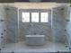 Elegant bathroom with marble tile, soaking tub, and glass shower at 210 Carl Sanders Dr, Acworth, GA 30101