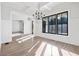 Sunlit dining room with hardwood floors, chandelier, and wainscoting at 210 Carl Sanders Dr, Acworth, GA 30101