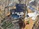Aerial view of the home's roof, deck, sunroom, driveway and the surrounding trees at 3536 Evans Ridge Trl, Atlanta, GA 30340