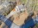 Aerial view of home with a large driveway and spacious front yard in a wooded neighborhood at 3536 Evans Ridge Trl, Atlanta, GA 30340