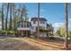 Expansive backyard featuring a multi-level deck, sunroom and patio area, perfect for outdoor entertaining at 3536 Evans Ridge Trl, Atlanta, GA 30340