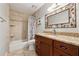 Updated bathroom with granite counters and a tiled shower/tub at 3536 Evans Ridge Trl, Atlanta, GA 30340