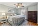 Bright bedroom with ceiling fan, wood floors, and a large window at 3536 Evans Ridge Trl, Atlanta, GA 30340