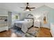 Cozy bedroom features a ceiling fan, natural light, and hardwood floors at 3536 Evans Ridge Trl, Atlanta, GA 30340