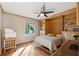 Neutral bedroom with built-ins, a ceiling fan, and wood floors at 3536 Evans Ridge Trl, Atlanta, GA 30340