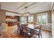 Open floorplan dining room showcasing hardwood floors, natural light, and connection to the kitchen at 3536 Evans Ridge Trl, Atlanta, GA 30340