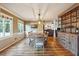 Dining area featuring wood floors, an elegant light fixture, and a view of the living area at 3536 Evans Ridge Trl, Atlanta, GA 30340