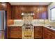 Gourmet kitchen featuring stainless steel appliances, granite countertops, and custom cabinetry at 3536 Evans Ridge Trl, Atlanta, GA 30340