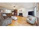Bright living room featuring hardwood floors, a fireplace, and comfortable seating arrangements at 3536 Evans Ridge Trl, Atlanta, GA 30340