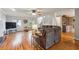 Open-concept living room featuring hardwood floors, a staircase, and ample natural light at 3536 Evans Ridge Trl, Atlanta, GA 30340