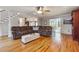 Comfortable living room featuring a brown sectional sofa, hardwood floors, and a white ottoman at 3536 Evans Ridge Trl, Atlanta, GA 30340