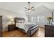 Spacious main bedroom features a ceiling fan, wood floors, and natural light at 3536 Evans Ridge Trl, Atlanta, GA 30340