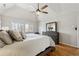 Comfortable main bedroom features hardwood floors, large windows, and a ceiling fan at 3536 Evans Ridge Trl, Atlanta, GA 30340