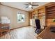 Office boasts built-in shelving, wood floors, and a ceiling fan at 3536 Evans Ridge Trl, Atlanta, GA 30340