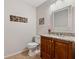 Charming powder room featuring granite countertop vanity, decorative mirror, and stylish wall art at 3536 Evans Ridge Trl, Atlanta, GA 30340