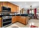 Kitchen with wood cabinets, stainless steel appliances, and granite countertops at 1680 Perserverence Hill Nw Cir # 23, Kennesaw, GA 30152