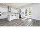 Modern kitchen with white cabinets and breakfast bar at 317 Lavender Ln, Holly Springs, GA 30115