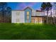 Modern farmhouse exterior at night with lawn at 140 Wesley Pl, Fayetteville, GA 30214