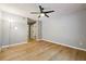 Bedroom featuring wood-look floors, neutral paint, a ceiling fan, and closet and bathroom access at 2824 Vinings Central Se Dr # 146, Atlanta, GA 30339