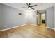 Spacious bedroom featuring wood-look floors, neutral paint, a ceiling fan, and access to the bathroom at 2824 Vinings Central Se Dr # 146, Atlanta, GA 30339