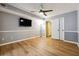 Bedroom featuring wood-look flooring, a ceiling fan, and access to a closet and ensuite bathroom at 2824 Vinings Central Se Dr # 146, Atlanta, GA 30339