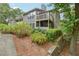 View of the back of a two-story condo building with decks and landscaping at 2824 Vinings Central Se Dr # 146, Atlanta, GA 30339