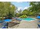 Exterior photo of the community pool with lounge chairs and picnic tables at 2824 Vinings Central Se Dr # 146, Atlanta, GA 30339