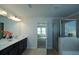 Double vanity bathroom with a large mirror and a walk-in shower at 309 Bowfin Trl, Mcdonough, GA 30253