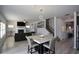 Open concept dining area with marble table and view of living room at 309 Bowfin Trl, Mcdonough, GA 30253