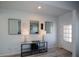 Bright entryway with a console table, mirrors, and wood-look floors at 309 Bowfin Trl, Mcdonough, GA 30253