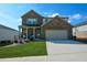 Two-story brick home with a large driveway and landscaped lawn at 309 Bowfin Trl, Mcdonough, GA 30253