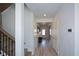 Long hallway with light walls, wood-look floors, and staircase at 309 Bowfin Trl, Mcdonough, GA 30253